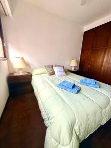 a bedroom with a large bed with towels on it at Amardel in Mar del Plata