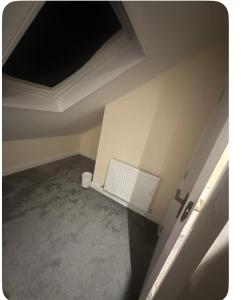 an empty room with a ceiling and a radiator at 62 Iveagh close in London