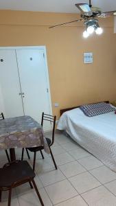 a bedroom with a bed and a table and chairs at Departamento Bolívar a 2 cuadras de la costa in Mar del Plata