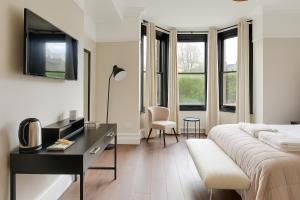 a white room with a bed and a desk and windows at NOW OPEN! Brand new rooms City Centre Modern Ensuite Rooms by Luxiety Stays in Cambridge
