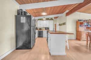 a kitchen with a large refrigerator and a counter at Breaking Waves Retreat in Depoe Bay