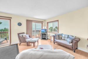 a living room with a bed and chairs and a television at Breaking Waves Retreat in Depoe Bay +35 photos