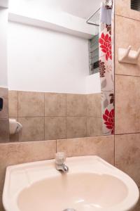 a bathroom with a sink and a shower at Villa Betty B&B in Cusco