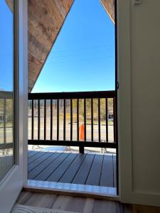 an open door with a view of a deck at Glacier Alpine Escape in East Glacier Park