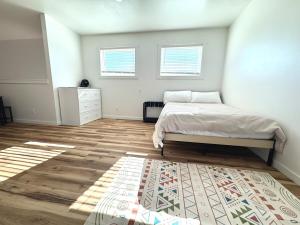 a bedroom with a bed and a rug at Glacier Alpine Escape in East Glacier Park