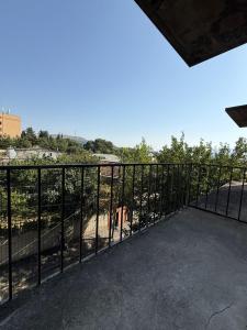 a metal fence with a view of a hill at Nest Stay in Tbilisi City +54 photos