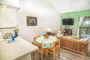 a living room with a table and a couch at Gateway Condo A25 in Mendon