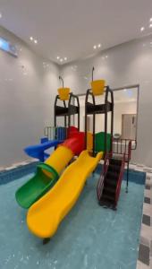 a play room with a slide and a pool at دهم الرمك in Khamis Mushayt