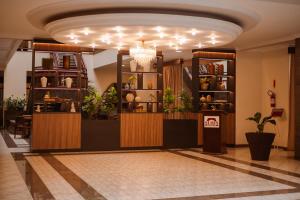 a lobby with a store with plants and a chandelier at Susin Hotel in Mafra