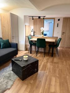 a living room with a table and a couch at URBAN BASE CELJE Apartment with FREE Parking & Terrace in Celje