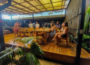 a group of people sitting at a table in a restaurant at Viajero San José Hostel in San José