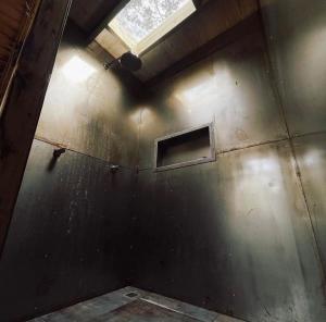 a room with a wall with a window in it at Green Valley Bus Cabin in Urubici