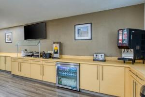 a waiting room with a drink machine and a tv at TownePlace Suites Raleigh Cary/Weston Parkway in Cary