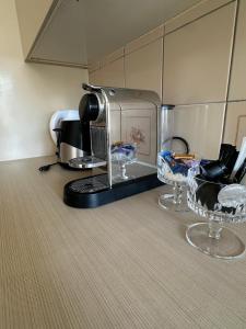 a coffee maker and two wine glasses on a counter at BelliCastelApartment in Bellinzona +14 photos