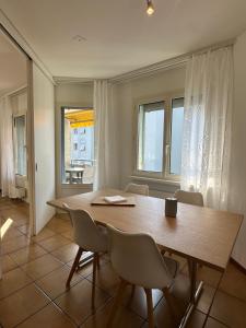 a dining room with a wooden table and chairs at BelliCastelApartment in Bellinzona