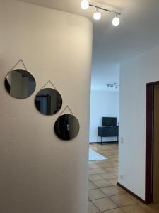 a hallway with two mirrors on a wall at BelliCastelApartment in Bellinzona