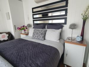 a bedroom with a bed with a black and white headboard at The Cube in Martinborough  +1 photo
