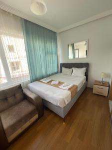 a bedroom with a bed and a couch at Kalamari pansiyon 2 in Adalar +14 photos