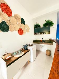 a kitchen with a table and some plates on the wall at Pousada Nascente do Sol in Ilha de Boipeba +173 photos