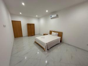 a bedroom with a bed in a white room at GP Apartamentos in São Filipe