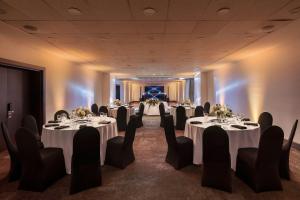 a set of tables in a room with chairs at Four Points by Sheraton Santiago in Santiago +104 photos