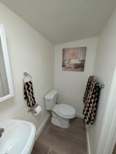 a bathroom with a white toilet and a sink at Casa Valencia in Tucson +12 photos