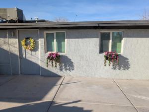 a house with two windows with flowers on it at Casa Valencia in Tucson