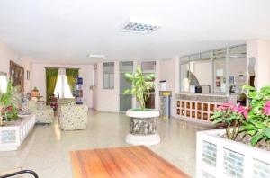 a large room with potted plants in it at Apartamentos Costamar in Los Cristianos