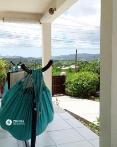 a green bag hanging on the side of a porch at Zinnia Apartments Antigua in Potters Village