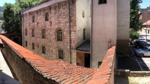 an old brick building with a red tile roof at Old Town 33 in Sarajevo
