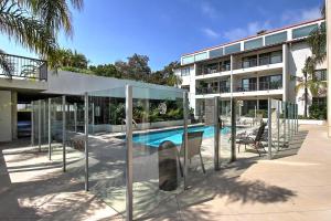a building with a swimming pool in front of a building at Leadbetter Beach Retreat in Santa Barbara