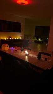 a living room with a table with lights on it at Villa luxueuse Halloween in Villetelle