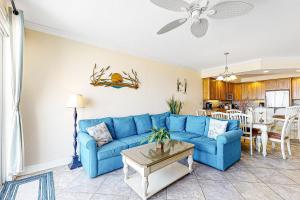 a living room with a blue couch and a table at Belmont Towers 401 in Ocean City