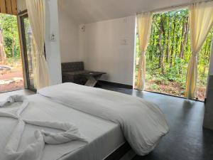 a bedroom with a large bed and a large window at Royal Villa Resort in Birgi +14 photos