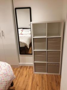 a bedroom with a dresser with a mirror and a bed at Modern 1 Bed City Centre Flat in Nottingham
