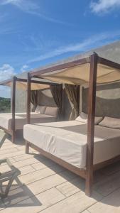 two beds under a canopy on a roof at Tuk Tulum Estudio con Balcon 005 in Tulum +28 photos
