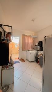a kitchen with a refrigerator and a dog laying on the floor at Lindo sobrado in Uruguaiana