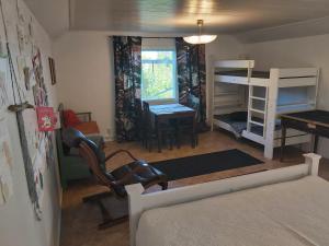 a bedroom with a bed and a desk and bunk beds at Rooms in a big wooden home, homestay in Muonio