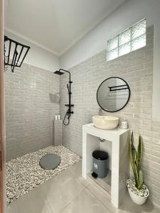 a bathroom with a sink and a mirror at Amed Happy House in Amed