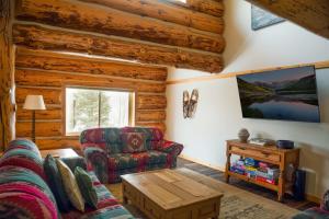 a living room with a couch and a chair at Silverthorne Cabin with Hot Tub and Forest Access in Silverthorne