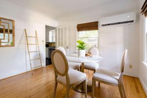 a dining room with a white table and chairs at Stay Portland - The Ladd's Addition Bohemian Dream - 95 WalkScore in Portland