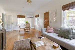 a living room with a couch and a table at Stay Portland - The Ladd's Addition Bohemian Dream - 95 WalkScore in Portland +8 photos