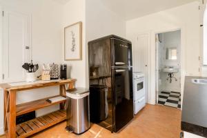a kitchen with a large black refrigerator in a room at Stay Portland - 1892 Bohemian Dream Studio in Ladd's Addition in Marquam Hill
