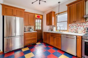 a kitchen with wooden cabinets and stainless steel appliances at Stay Portland - 3BR Craftsman - Vintage Charm - Great Location in Portland