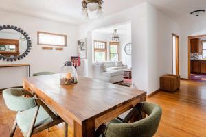a living room with a wooden table and chairs at Preserved 1907 Classic 2BR - 92 WalkScore in Portland