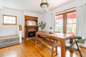 a dining room with a table and a fireplace at Preserved 1907 Classic 2BR - 92 WalkScore in Portland