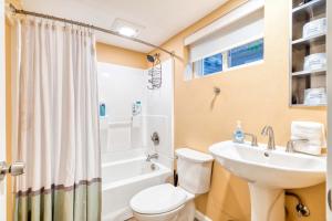 a bathroom with a white toilet and a sink at Stay Portland - Private Underground Getaway - 92 WalkScore in Portland