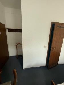 a room with a door and a chair and a table at Haus Danz in Brühl