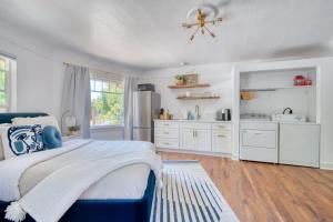a bedroom with a blue bed and white cabinets at Serene Forest Studio - Walk to Multnomah Village in Portland +25 photos