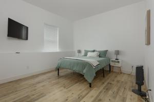 a bedroom with a bed and a flat screen tv at Columbia Gorge Getaway - Walk to River & Trails in Stevenson